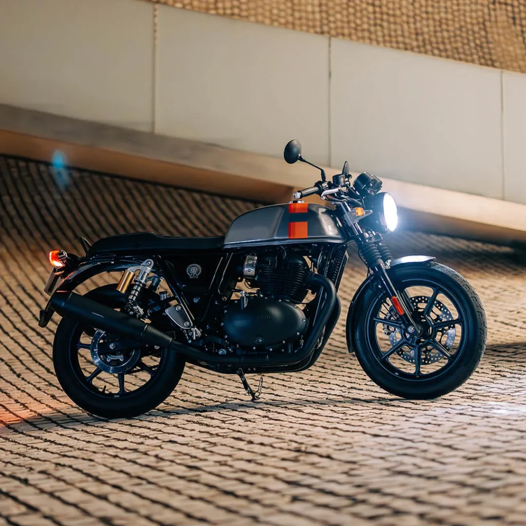 Royal Enfield Bullet with headlights on riding over sand