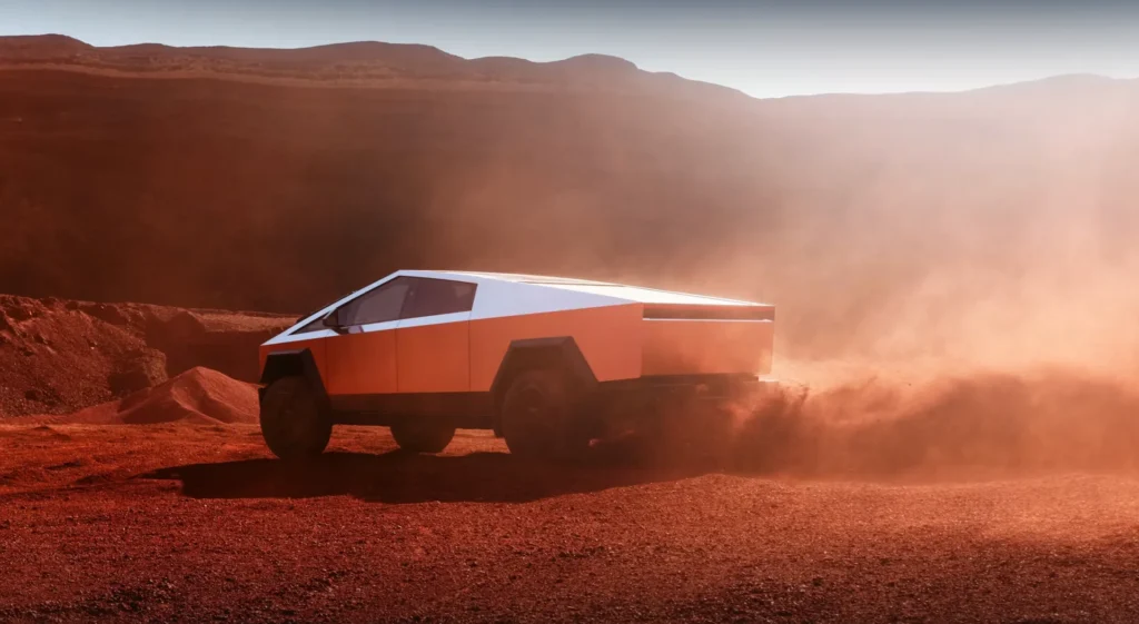 Tesla Cybertruck driving through a dusty, red Martian-like landscape, with the vehicle's unique design highlighted against the barren terrain.
