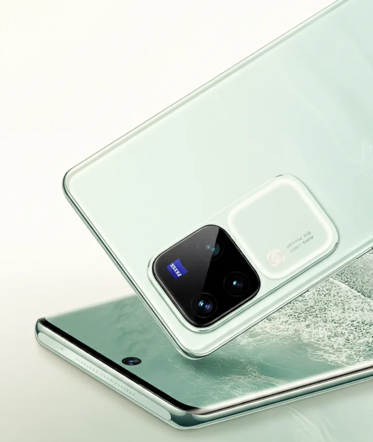 A close-up shot of two light green 5G curved display phones, one resting on top of the other, showcasing their camera modules and sleek design.