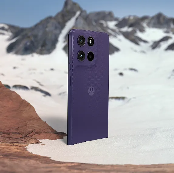 moto g67 power 5g price in india - A purple Motorola smartphone standing upright in a snowy, mountainous outdoor setting, showcasing its profile.